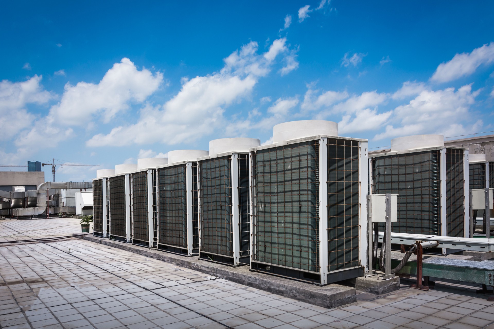 Industrial Rooftop Air Conditioning Units Under Clear Blue Sky